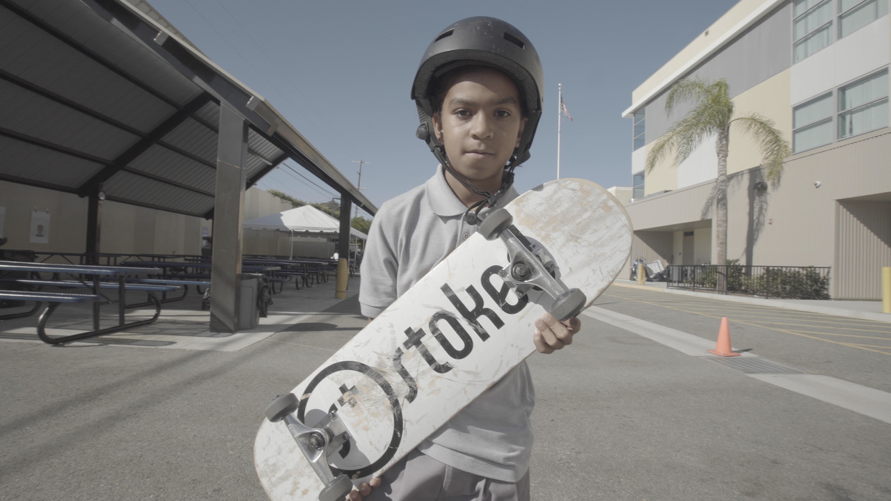 ICEF student with STOKED skateboard